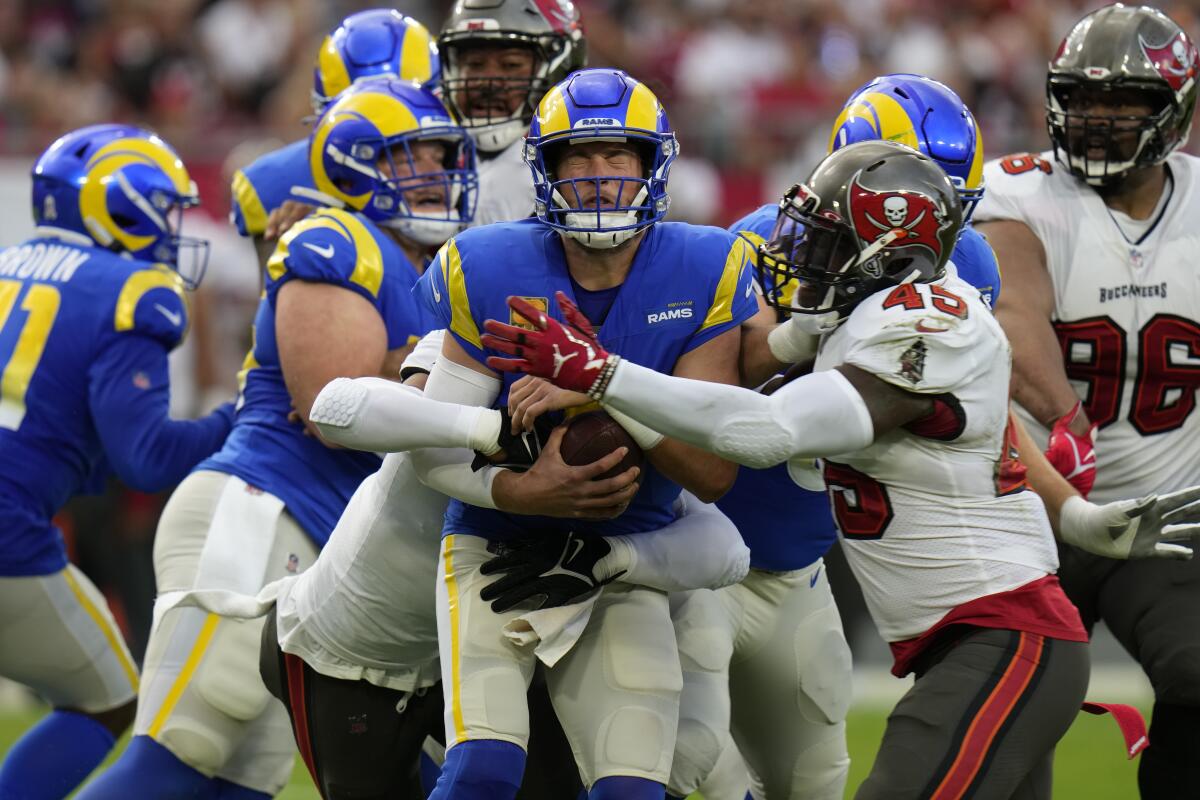 Rams quarterback Matthew Stafford (9) is hit by Buccaneers linebacker Devin White (45).