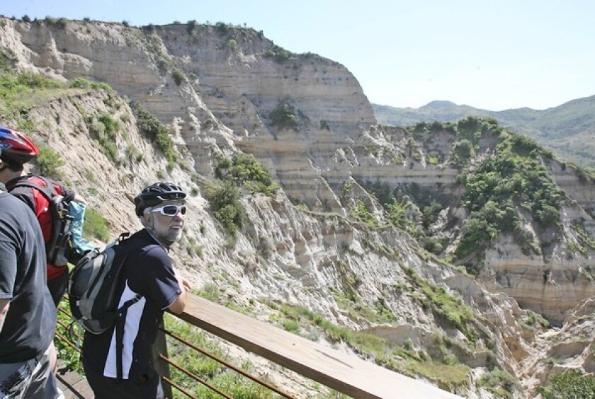 Mountain biker Mansoor Vakili takes in the expansive view of "The Sinks" from the new viewing deck at Limestone Canyon, which was dedicated by officials from Irvine Ranch Conservancy and OC Parks on Friday.