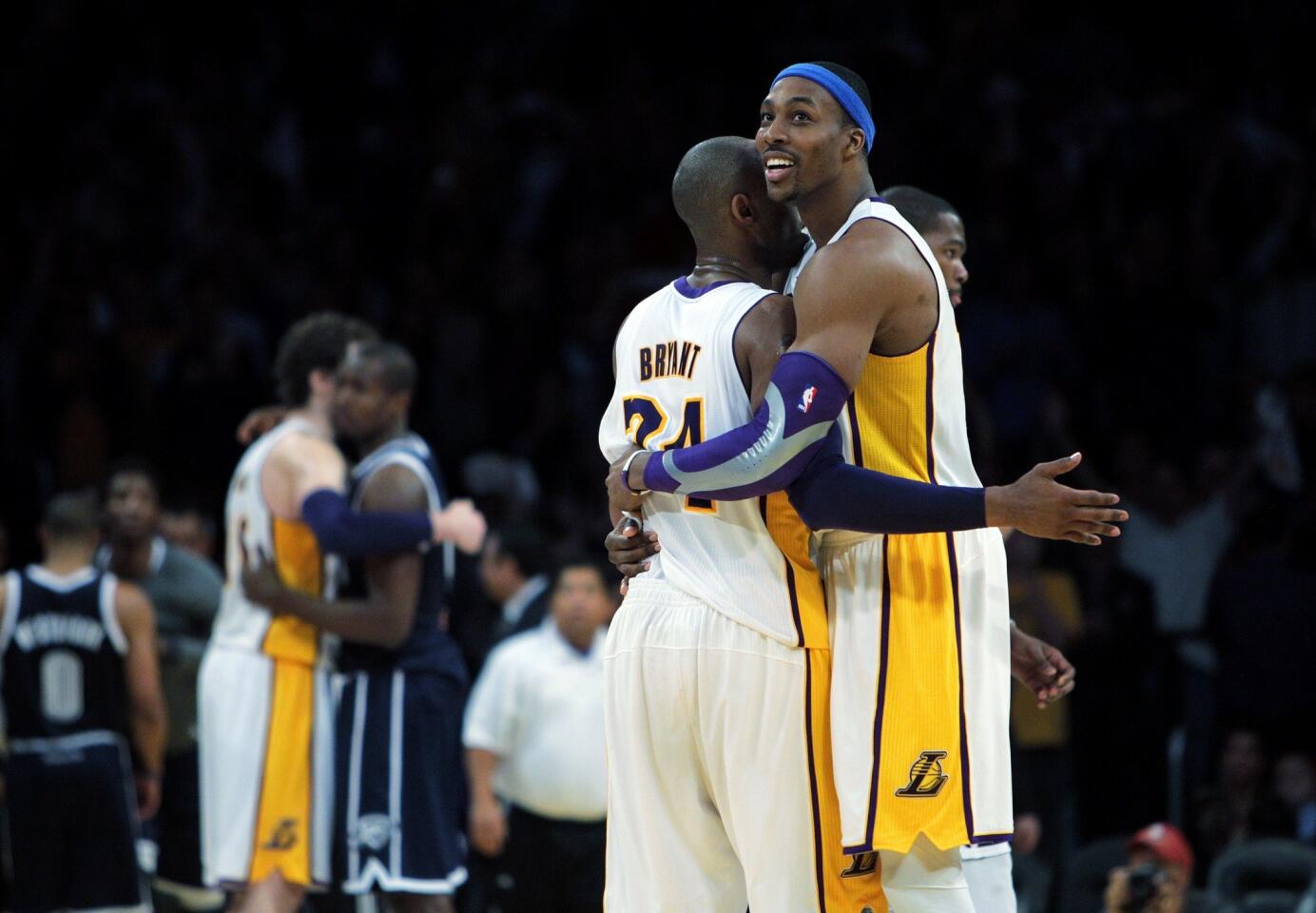 Lakers guard Kobe Bryant and center Dwight Howard embrace after defeating the Thunder, 105,96, on Sunday afternoon at Staples Center.