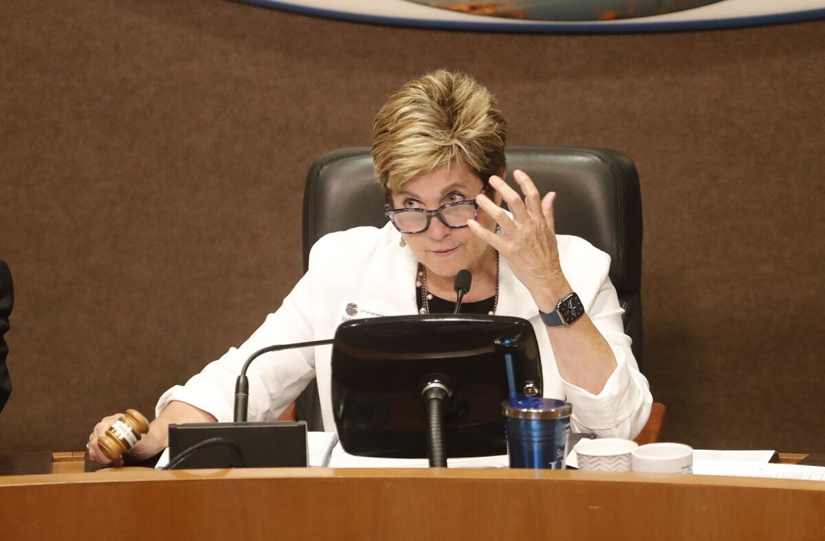 Mayor Barbara Delgleize reacts to the crowd and calls for order during Tuesday night's Huntington Beach City Council meeting.