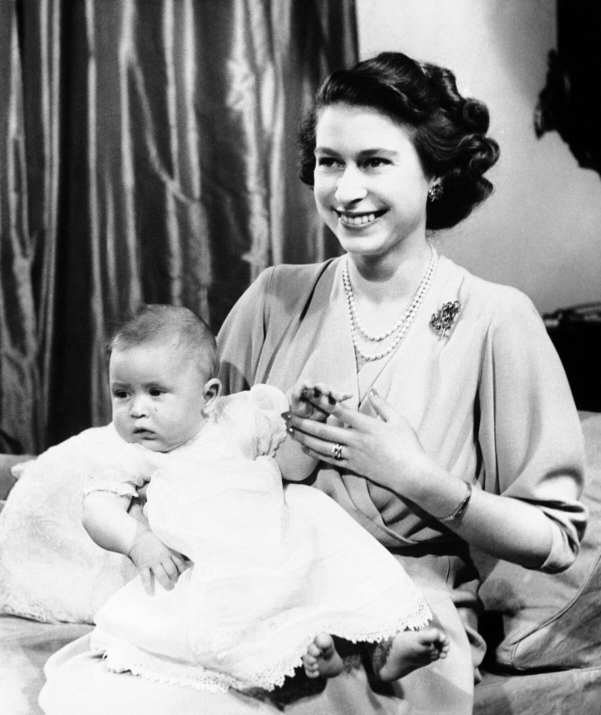 The then Princess Elizabeth with baby Prince Charles