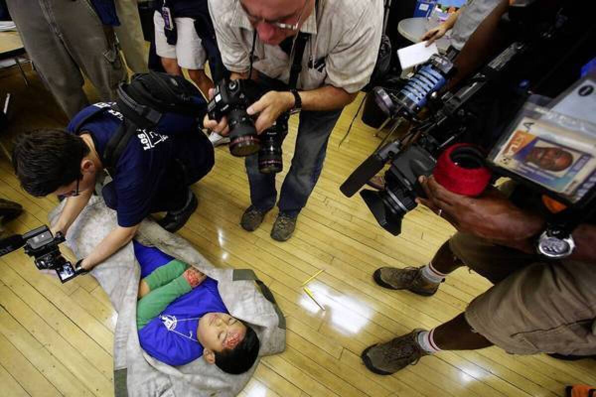 Leobely Hernandez, 11, a student at Rosemont Avenue Elementary School in L.A., participates as an injured victim in Thursday's Great California ShakeOut.