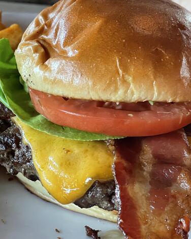 Hugo's beef burger with  bacon, cheese and avocado on a brioche bun. 