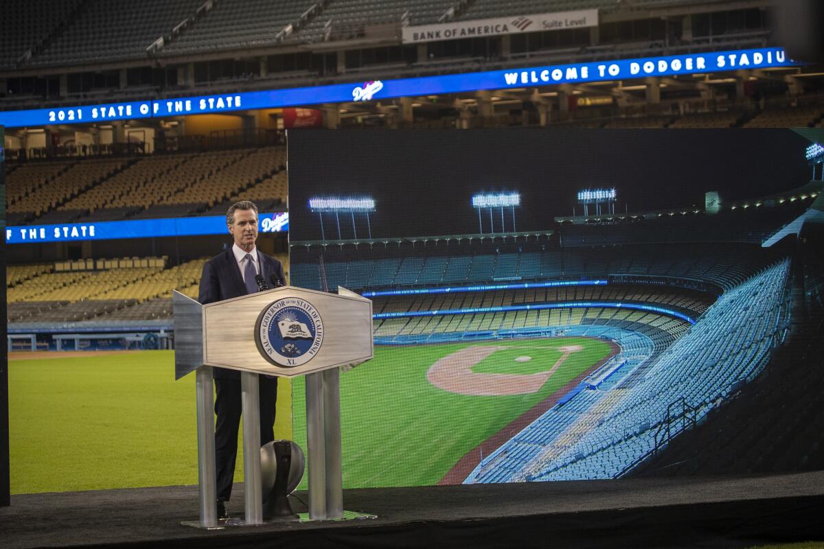 Gov. Gavin Newsom speaks in an empty Dodger Stadium.