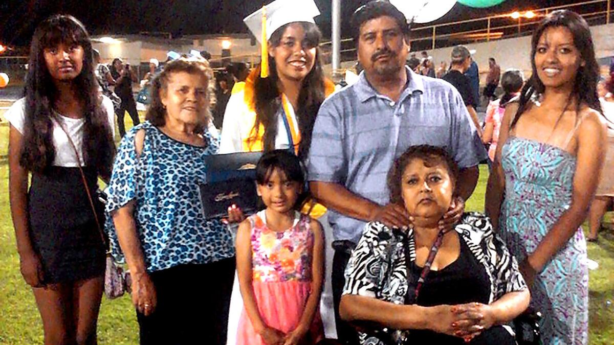 A June 2014 family photo shows Antonia Torres Cerda, in wheelchair, who died Nov. 8 at UCLA of an infection blamed on an Olympus scope. From left are daughter Joanna, mother Ramona Vargas, daughters Cynthia (in cap and gown) and Jessica, husband Armando and daughter Yenifer.