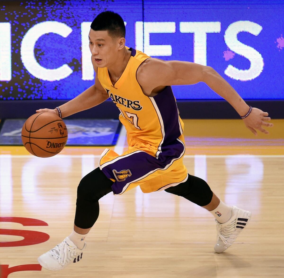 Jeremy Lin brings the ball up the court during the Lakers' season-opening loss to the Houston Rockets at Staples Center. Lin had seven points and six assists in the loss.