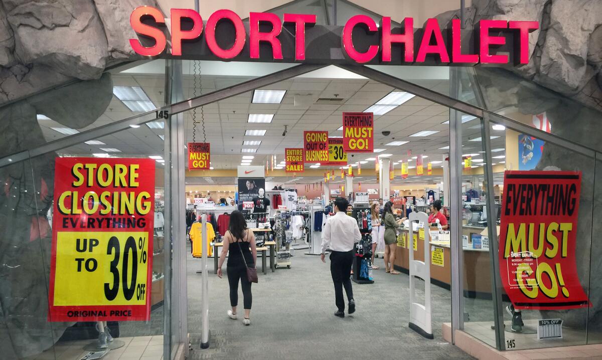 Shoppers look over the closeout deals at the Sports Chalet in the Burbank Town Center on Tuesday, April 21, 2016. The sporting goods chain's parent company announced they will be closing all of the Sports Chalet's.