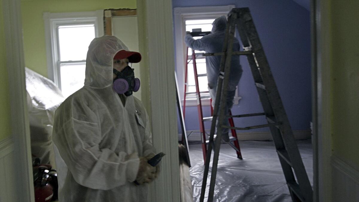Workers clean up lead paint in a contaminated building in Providence, R.I., in 2006.