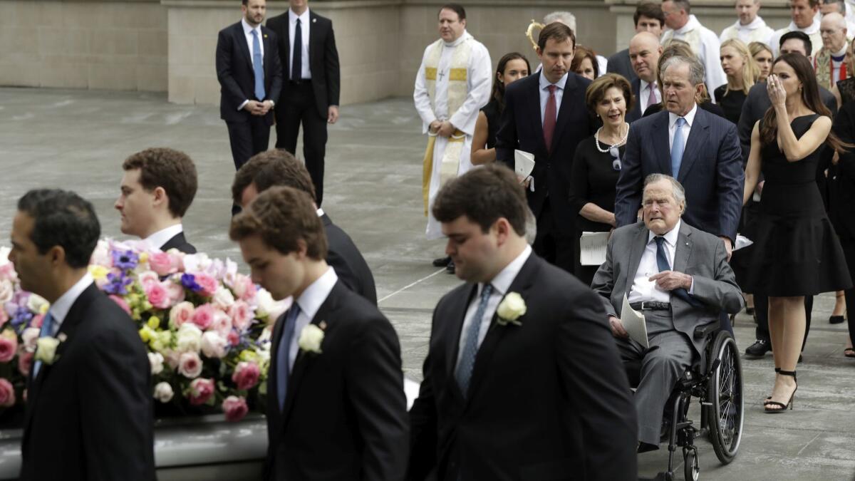 Former Presidents George W. and George H.W. Bush, along with former First Lady Laura Bush, follow pallbearers who carry the casket of former First Lady Barbara Bush after a funeral service Saturday, April 21, 2018, in Houston.