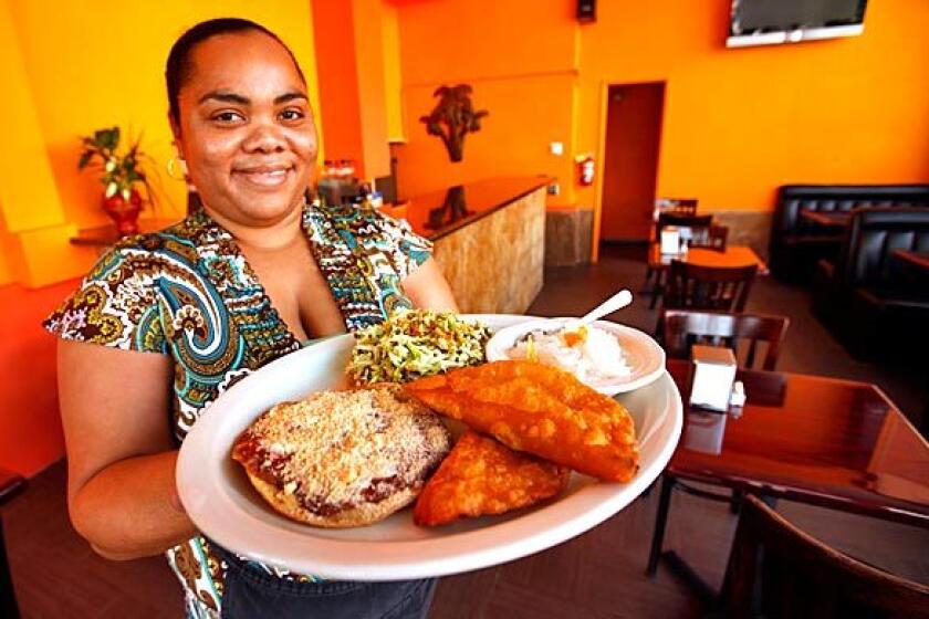 Tifara Smith shows a sampler platter at Flavors of Belize.