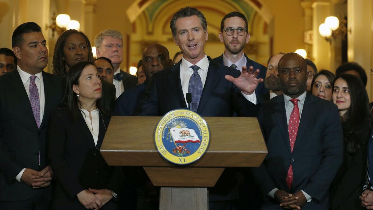 California Gov. Gavin Newsom in March discusses his decision to place a moratorium on the death penalty during a news conference at the Capitol, in Sacramento.