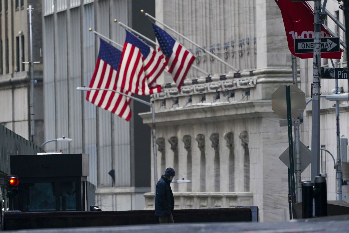 A security guard is seen next to a roadblock near the New York Stock Exchange.