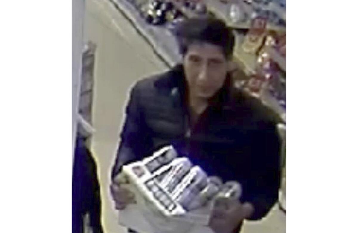 Surveillance camera image provided by police shows a man taking items from a restaurant in Blackpool, England.