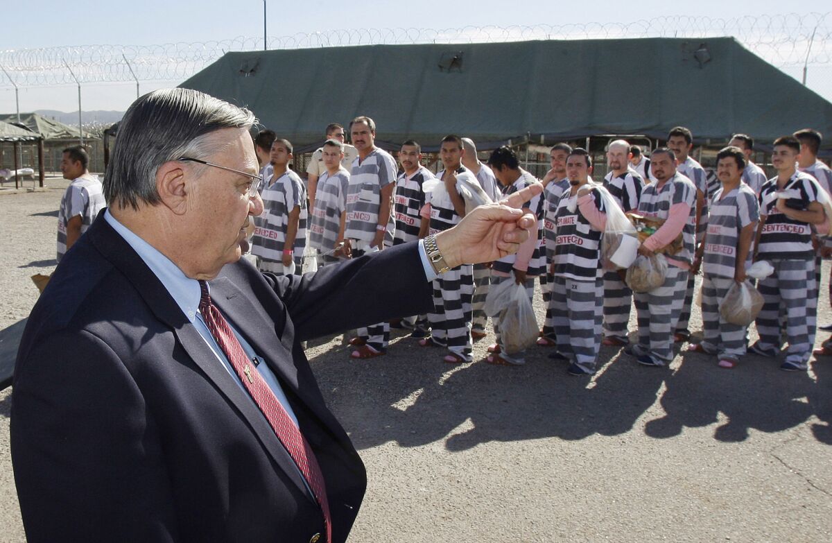 Maricopa County Sheriff Joe Arpaio orders convicts in the U.S. illegally to be handcuffed together in 2009 and moved into tents to serve their sentences before deportation.