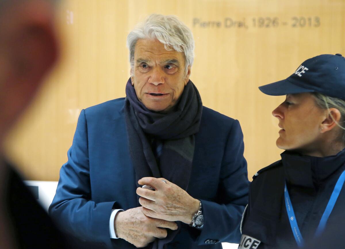 FILE - In this March 13, 2019 file photo, French tycoon Bernard Tapie arrives at Paris court house. Tapie, the charismatic president of French soccer club Marseille during its glory era whose reign was marred by a match-fixing scandal, died Sunday Oct. 3, 2021. He was 78. (AP Photos/Michel Euler, File)