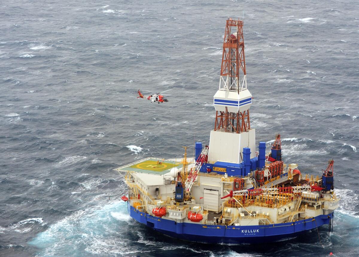 A Coast Guard helicopter rescues crew members from Shell's mobile drilling unit Kulluk off Alaska.