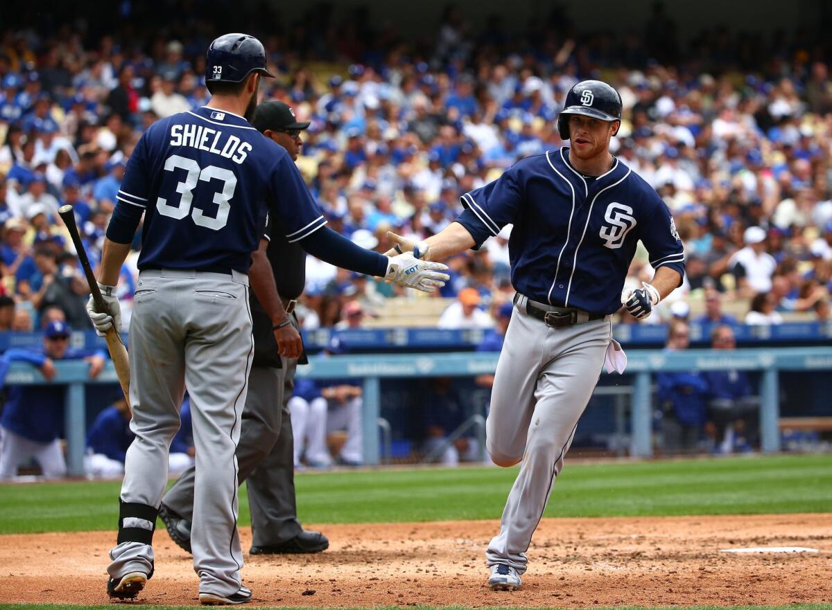 San Diego second baseman Cory Spangenberg is congratulated by pitcher James Shields after scoring in the fifth inning of a game Sunday against the Dodgers. The Padres beat the Dodgers, 11-3.