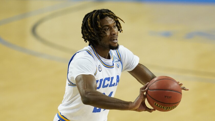 UCLA forward Jalen Hill passes the ball during a game.