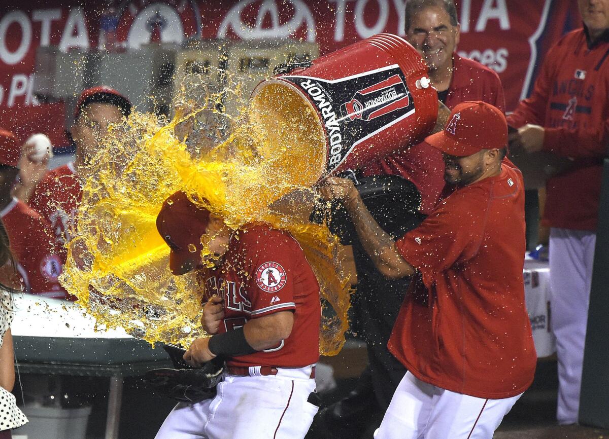 Kole Calhoun gets drenched after homering twice in the Angels' 3-0 win over Boston on Saturday night in Anaheim.