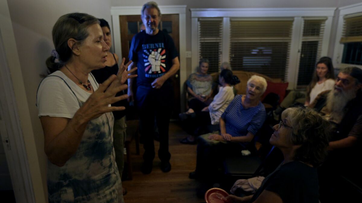 Lyn Pestana addresses Bernie Sanders supporters at a debate watch party at her home in Los Angeles.