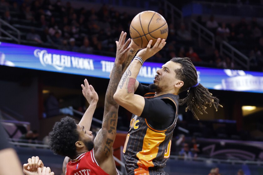 Orlando Magic guard Cole Anthony, right, shoots as Chicago Bulls guard Coby White defends in the first half of an NBA basketball game, Sunday, Jan. 23, 2022, in Orlando, Fla. (AP Photo/Joe Skipper)