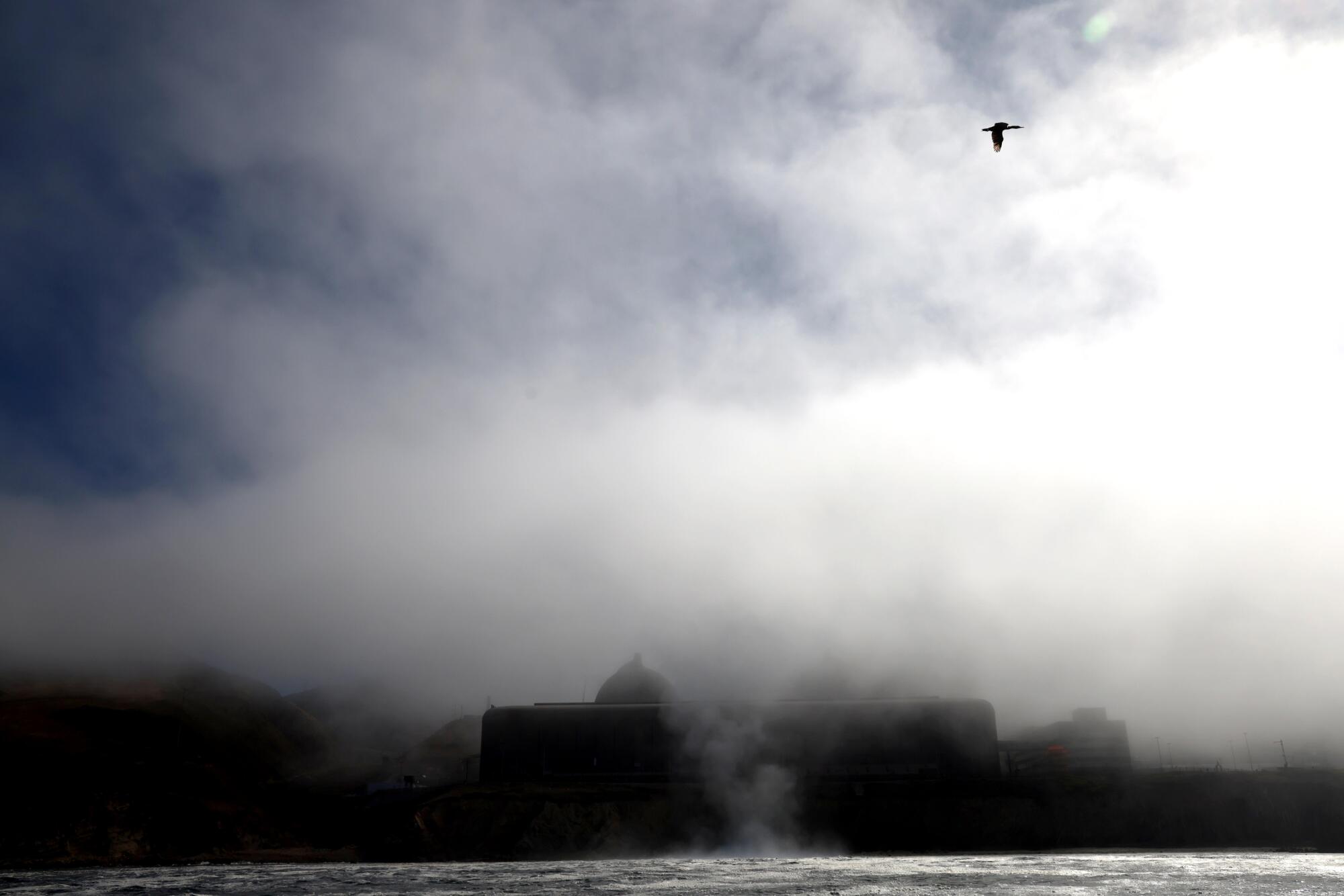 Steam rises from the sea near a nuclear power plant.