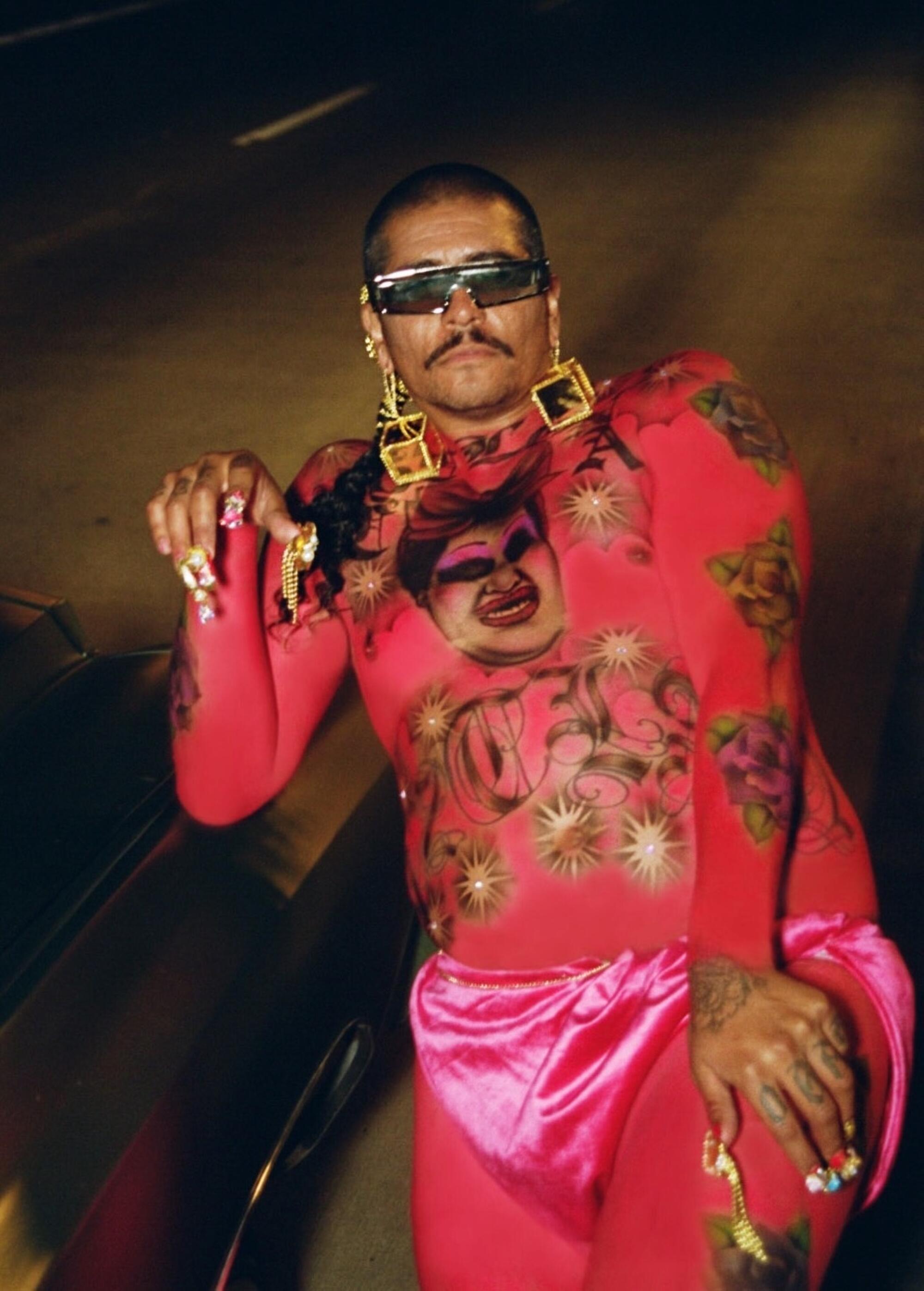 rafa esparza with a painted pink body in the style of a lowrider car