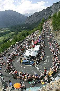 Fans crowd the course as Lance Armstrong climbs to Alpe d'Huez during Stage 16 of the Tour de France. Armstrong went on to win the individual time trial.
