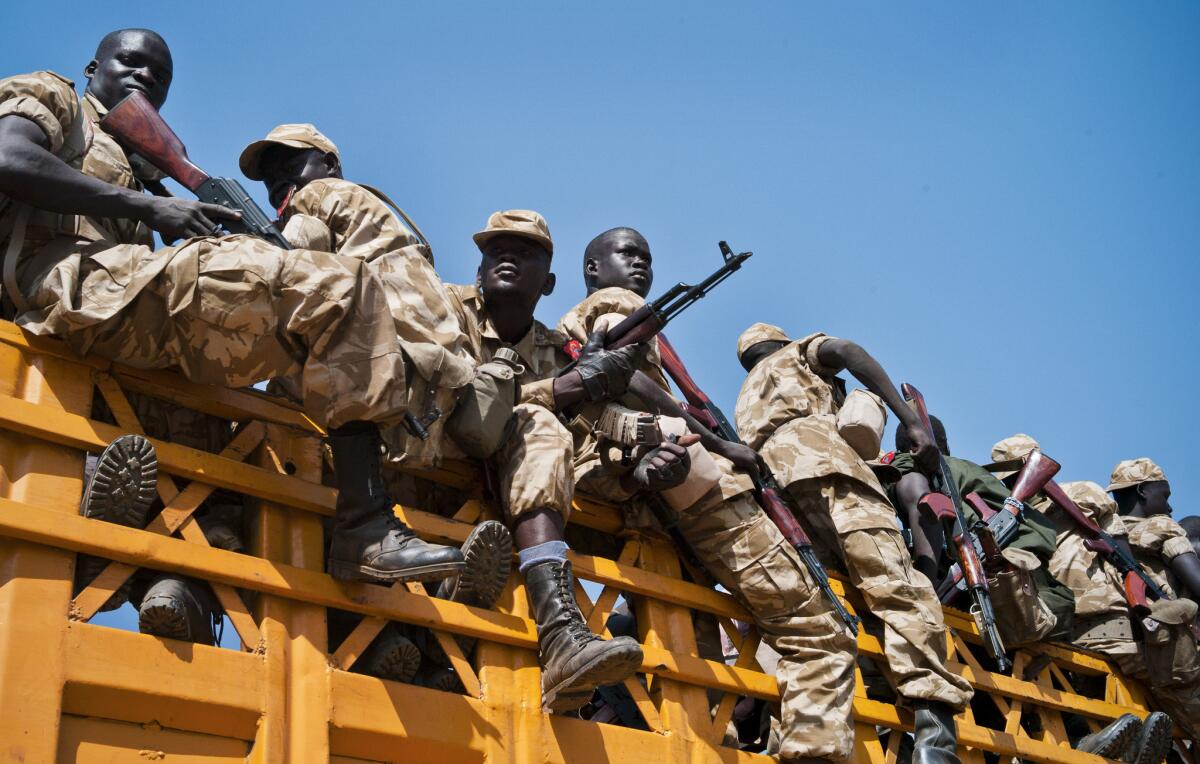 Some of the hundreds of South Sudanese government soldiers board lorries and pickup trucks last week as they prepare to leave Juba for the front line to battle rebel forces near the town of Bor.