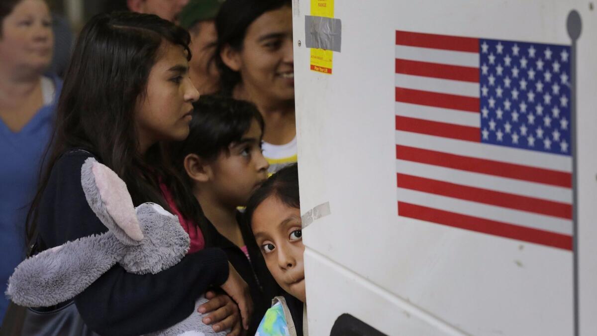 Immigrant children from El Salvador and Guatemala who entered the country illegally board a bus after they were released from a family detention center in San Antonio, Texas on July 7, 2015.