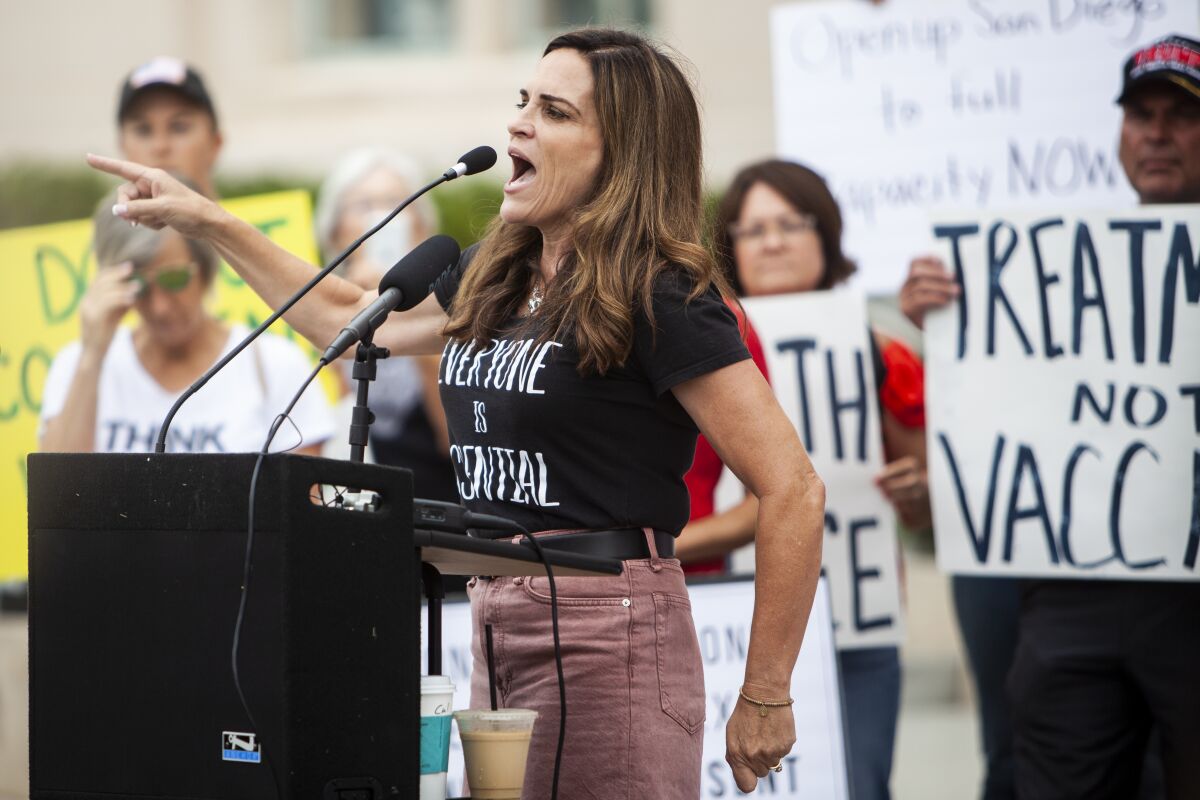ReOpen San Diego co-founder Amy Reichert speaks at a demonstration at the County Administration building.