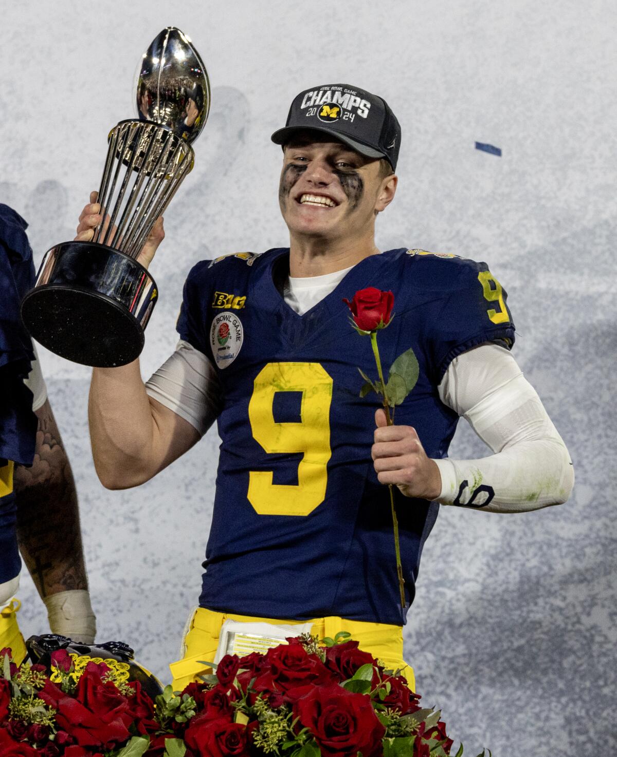 Michigan quarterback J.J. McCarthy celebrates with the Rose Bowl trophy after the Wolverines' win over Alabama.
