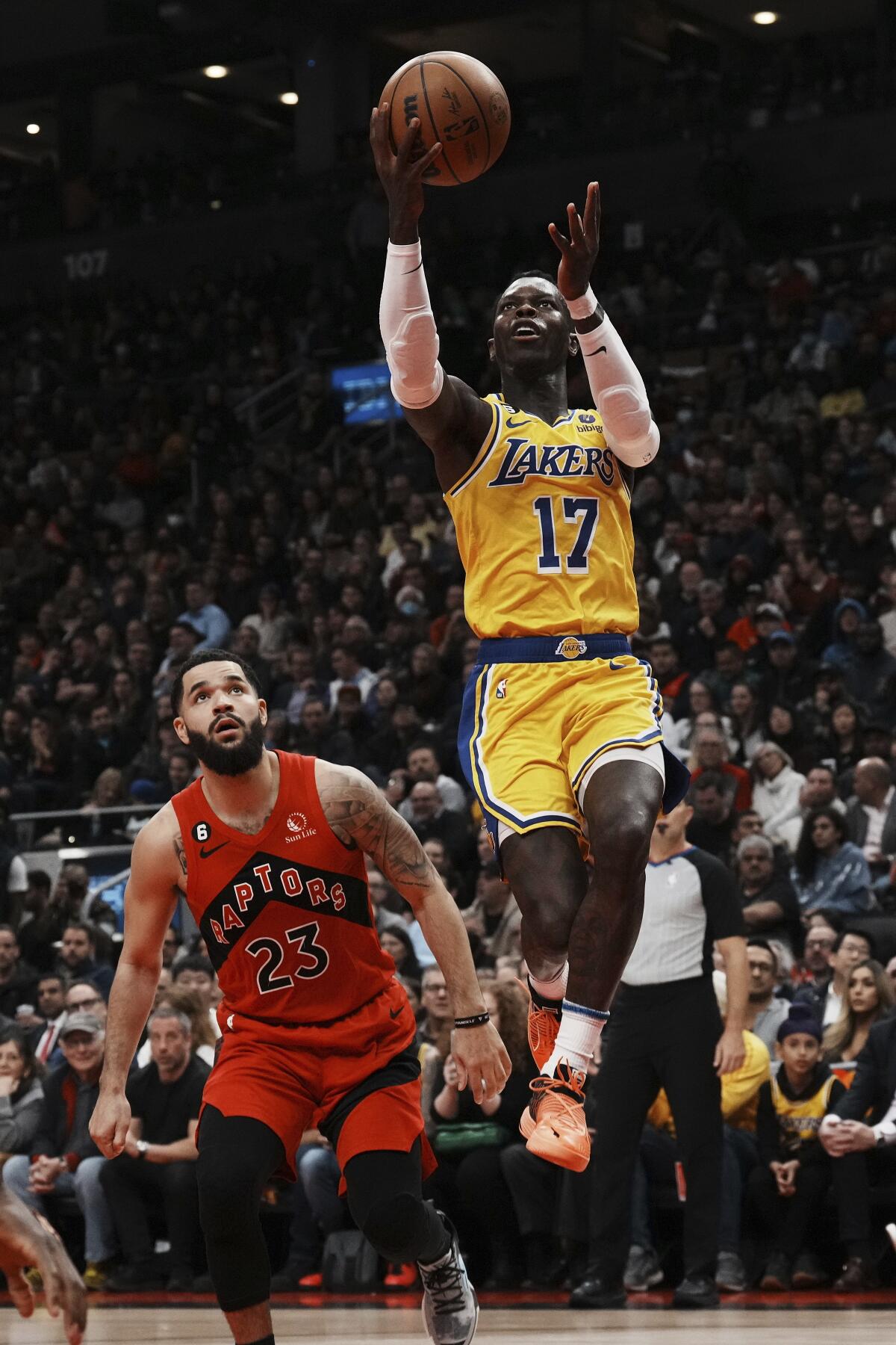 Lakers' Dennis Schroder shoots as Toronto Raptors' Fred VanVleet watches.