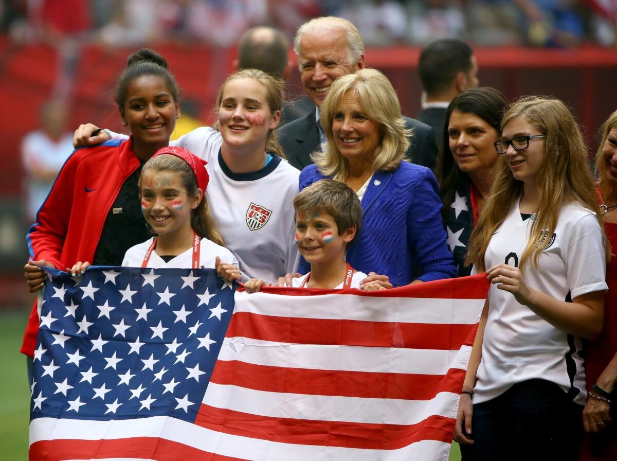 Vice President Joe Biden and Jill Biden, center, pose on the pitch with Mia Hamm, second from right, after the U.S. team's 5-2 victory against Japan in the FIFA Women's World Cup Final.