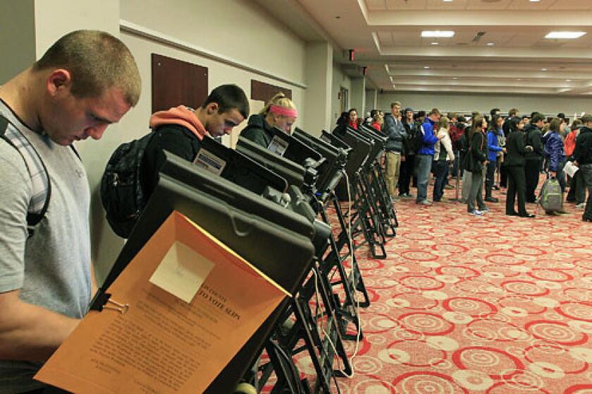 Voters stand in line waiting to cast their ballot at a polling station in Columbus, Ohio.