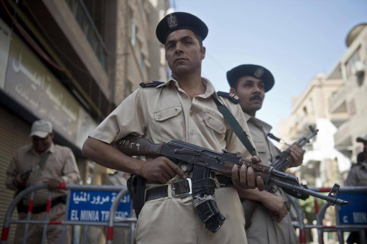 Members of the Egyptian security forces monitor the streets in the southern city of Minya on Monday, after a court sentenced more than 600 people to death.