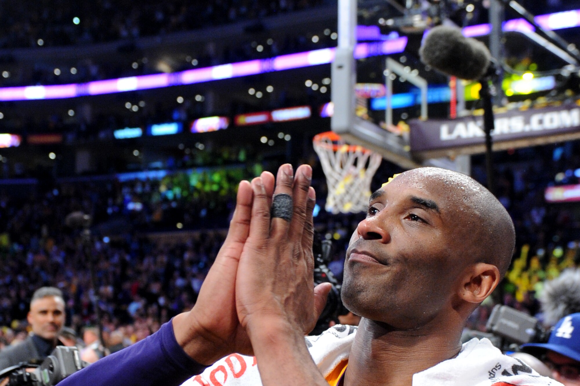 Lakers star Kobe Bryant pays homage to the crowd at Staples Center following the final game of his career on April 13, 2016.