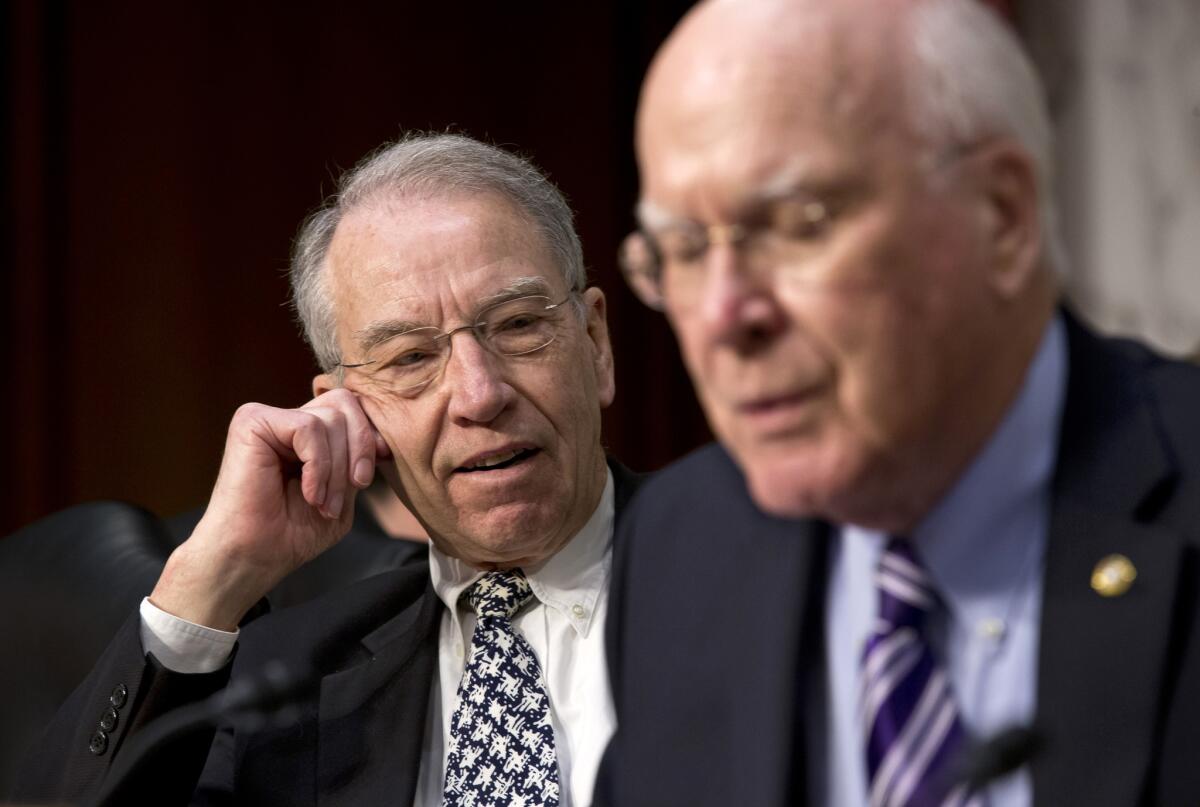 Sen. Charles Grassley (R-Iowa), left, pauses after a brief but heated response to remarks by Sen. Charles Schumer (D-N.Y.) during a Judiciary Committee hearing on immigration reform.
