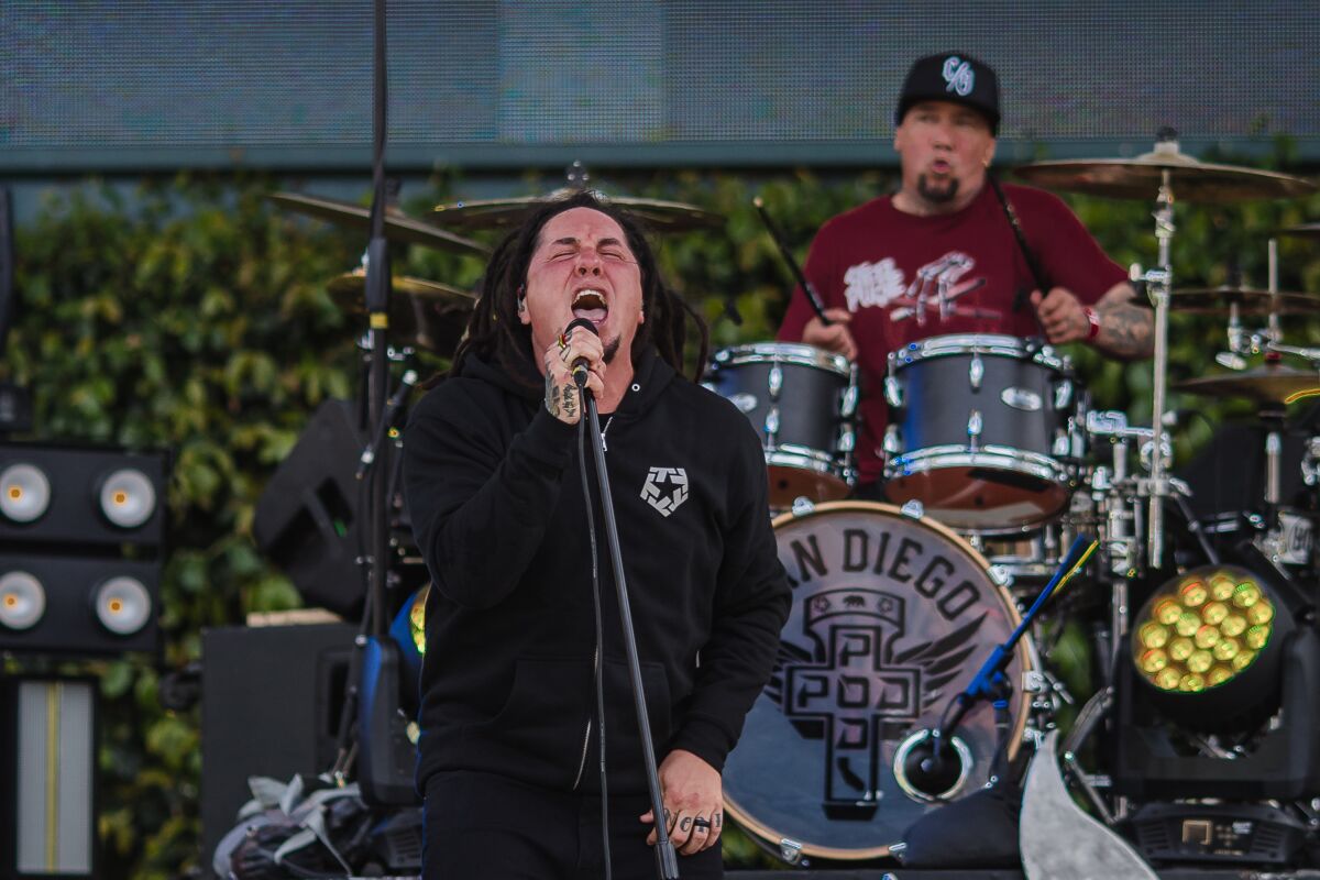 Singer Sonny Sandoval and drummer Wuv Bernardo of P.O.D perform in front of the cameras at Petco Park on April 14, 2021.