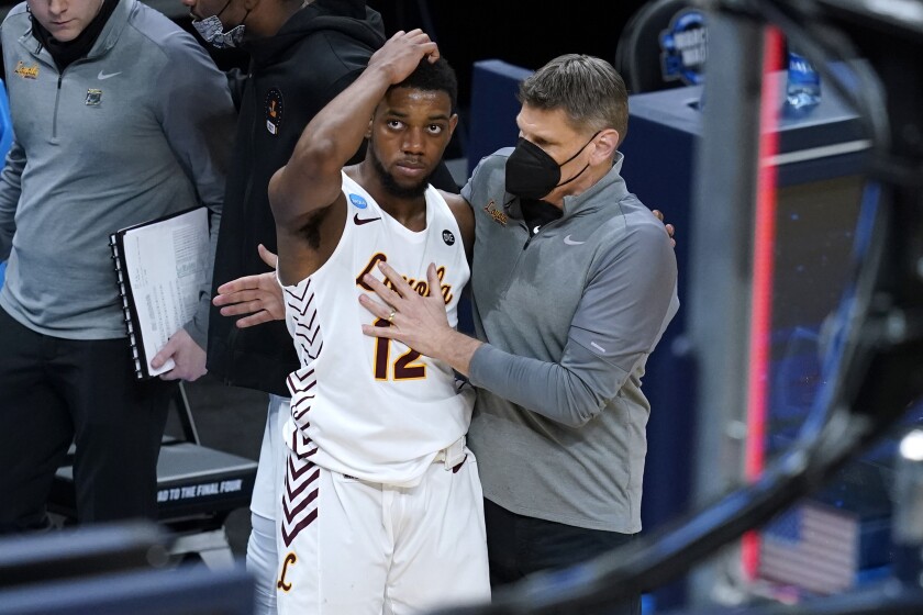 Loyola Chicago head coach Porter Moser, right, consoles guard Marquise Kennedy after a Sweet 16 game against Oregon State in the NCAA men's college basketball tournament at Bankers Life Fieldhouse, Saturday, March 27, 2021, in Indianapolis. Oregon State won 65-58. (AP Photo/Darron Cummings)