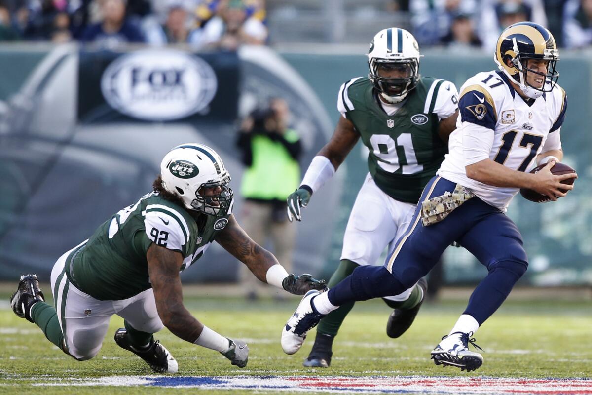 Rams quarterback Case Keenum scrambles from pressure of Jets defensive lineman Leonard Williams during the third quarter.