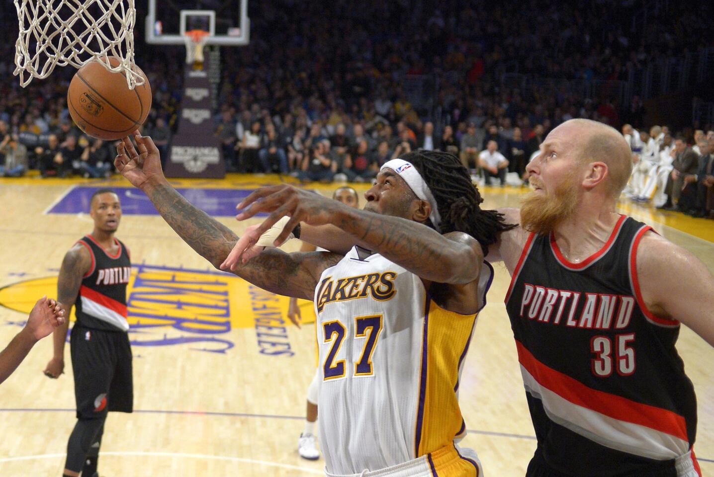 Lakers center Jordan Hill is fouled by Trail Blazers center Chris Kaman on a layup in the second half.