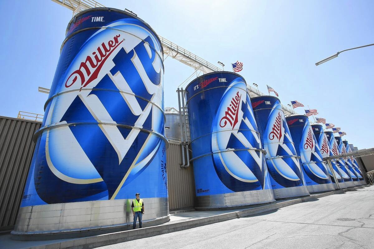 Edward Gharavi stands next to a 60-foot-tall tank containing 80,000 gallons of beer at the MillerCoors brewery in Irwindale in 2014. MillerCoors, a joint venture between SABMiller and Molson Coors Brewing Co., controls 28% of the U.S. beer market.