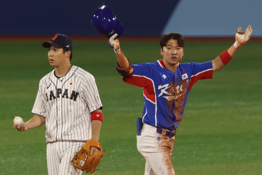 South Korea outfielder Hae Min Park celebrates next to Japan infielder Tetsuto Yamada 