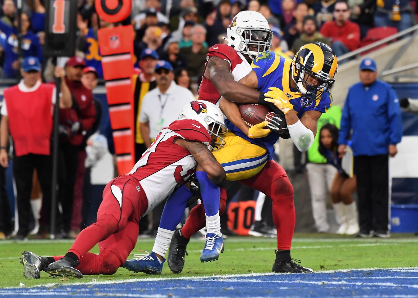 Rams wide receiver Robert Woods catches a touchdown pass in front of Cardinals safety Budda Baker, left, and cornerback Patrick Peterson.