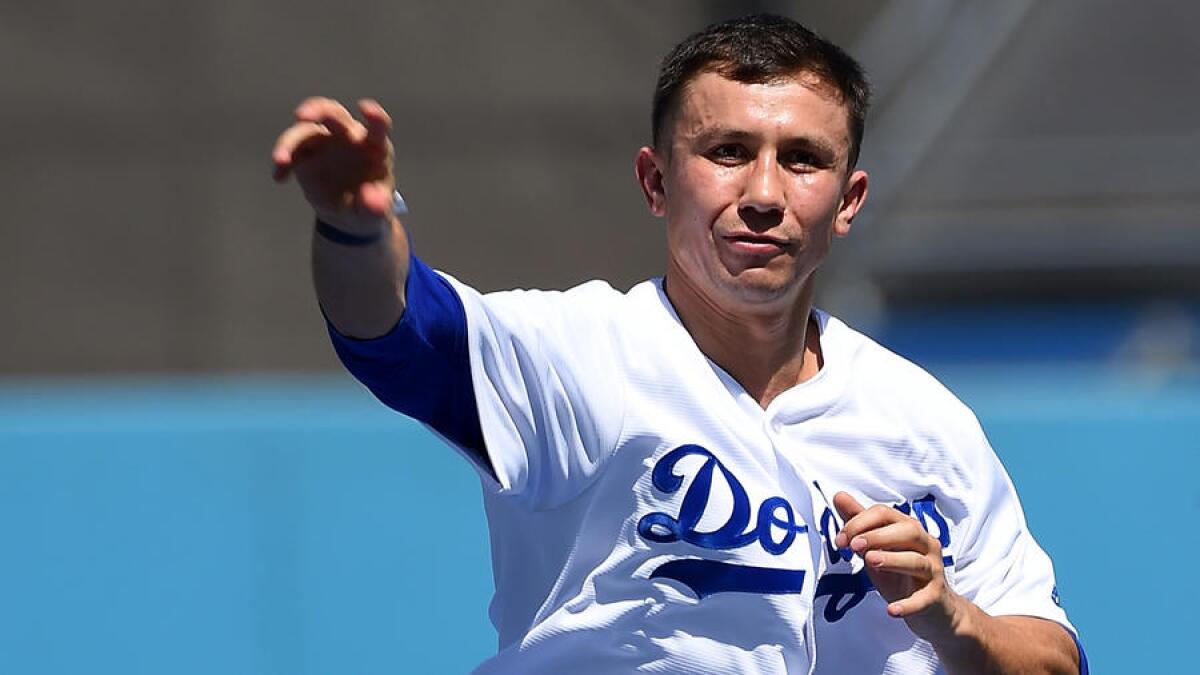 Gennady Golovkin throws out the ceremonial first pitch before the Dodgers' game against Colorado on Sunday.