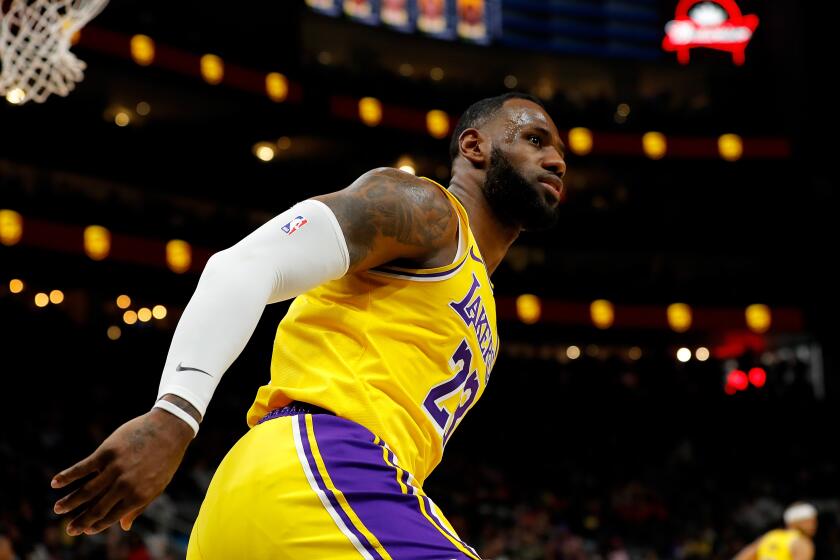 LeBron James heads back upcourt after dunking against the Hawks on Dec. 15, 2019, in Atlanta.