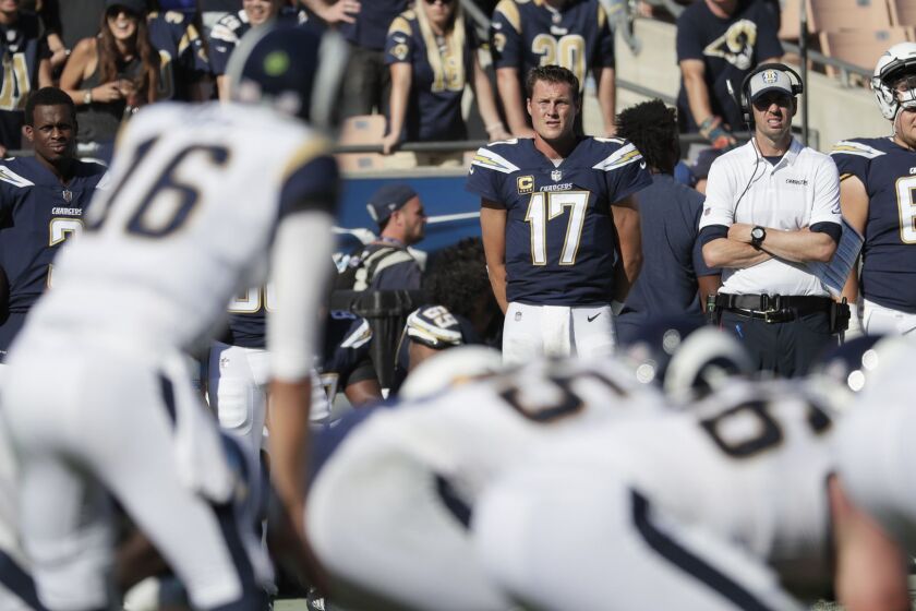 LOS ANGELES, CA, SUNDAY, SEPTEMBER 23, 2018 -Chargers quarterbacks Geno Smith, left, and Philip Rivers watch Rams quarterback Jared Goff lead the team at the Coliseum. (Robert Gauthier/Los Angeles Times)