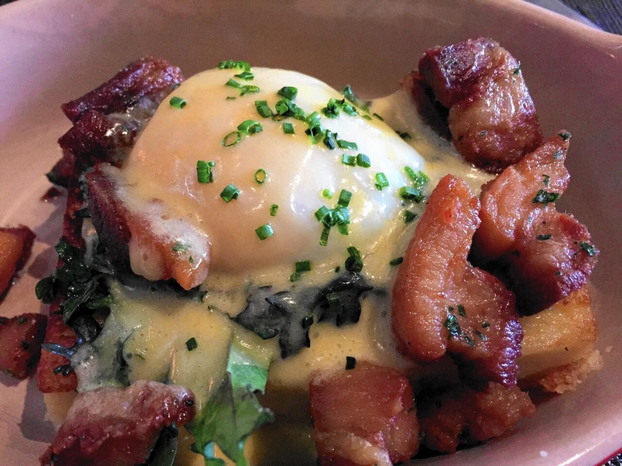 The Mac Attack, chef Jeremiah Bacon's creative Lowcountry take on classic Eggs Benedict, is garnished with pork belly at The Macintosh.