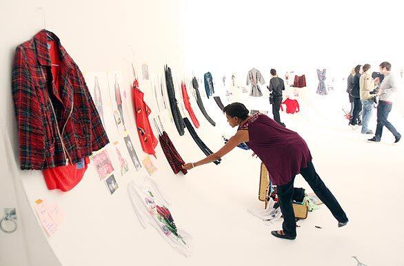 Guests and members of the media look over an installlation of the Whitley Kros Fall 2009 Collection on Sunday at the Miauhaus Studios for photography and art in Los Angeles.